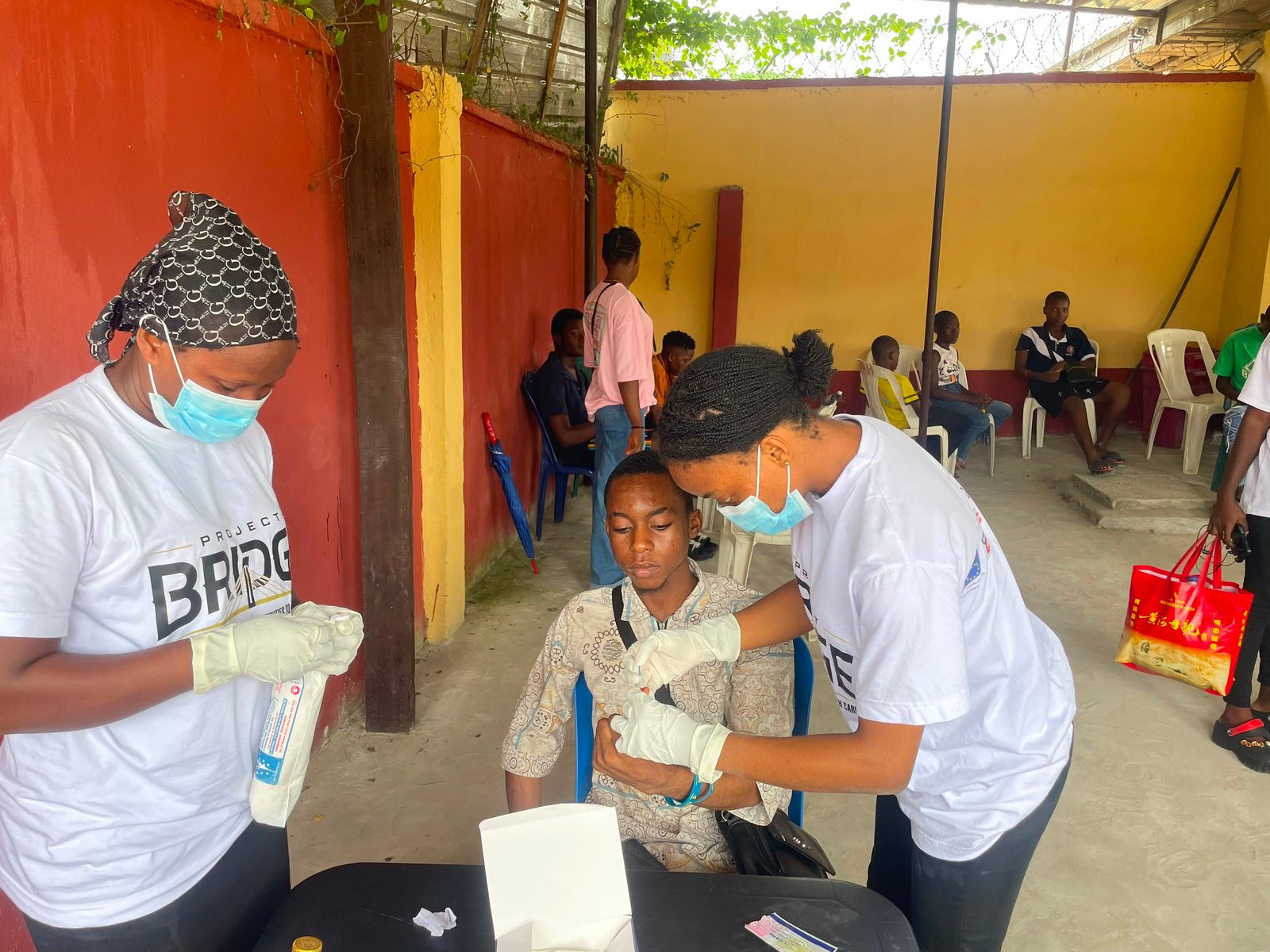 Hepatitis and HIV outreach volunteers screening a student